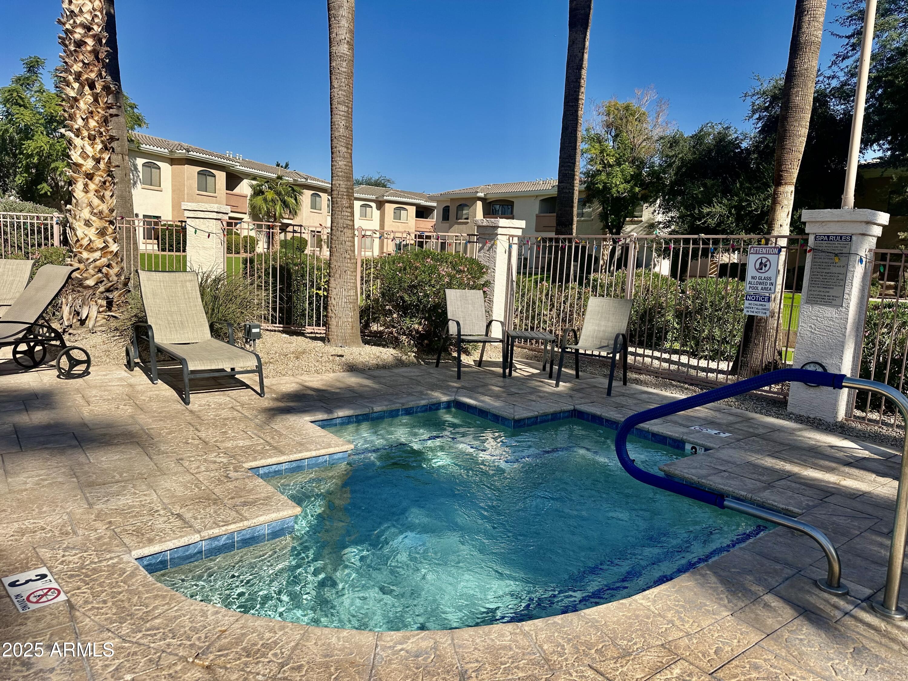 10030 West Indian School Road, Unit 227 Phoenix, AZ 85037 - Photo 4 of 22 a view of a swimming pool with a patio