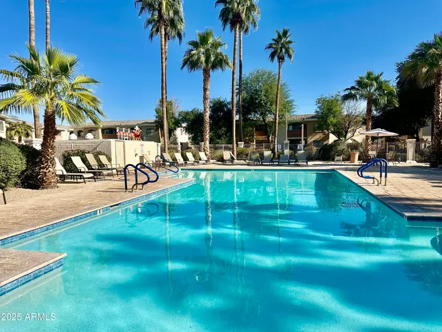 a view of a swimming pool with a table and chairs