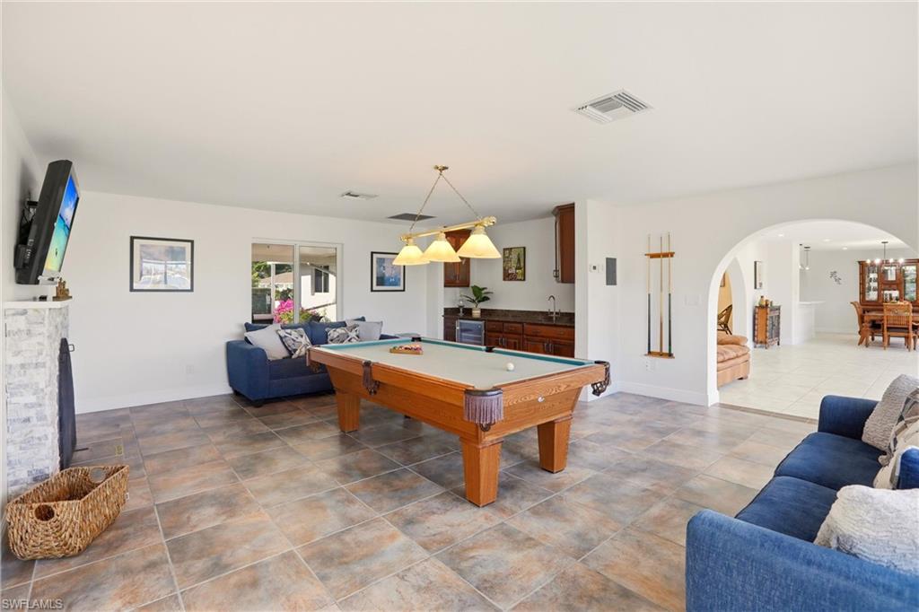 339 Landmark Street Marco Island, FL 34145 - Photo 32 of 50 Recreation room with pool table, arched walkways, a fireplace, and wine cooler