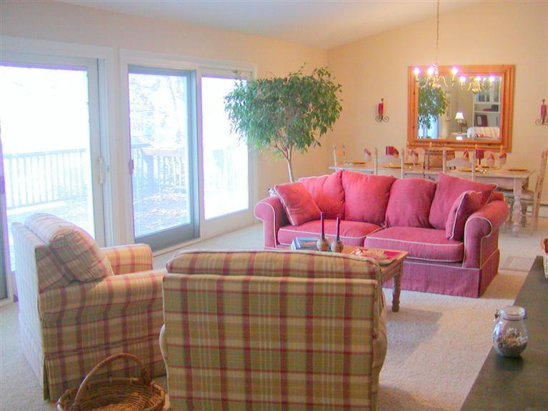 168 Holly Point Road Centerville, MA 02632 - Photo 9 of 28 a bedroom with furniture and a large window