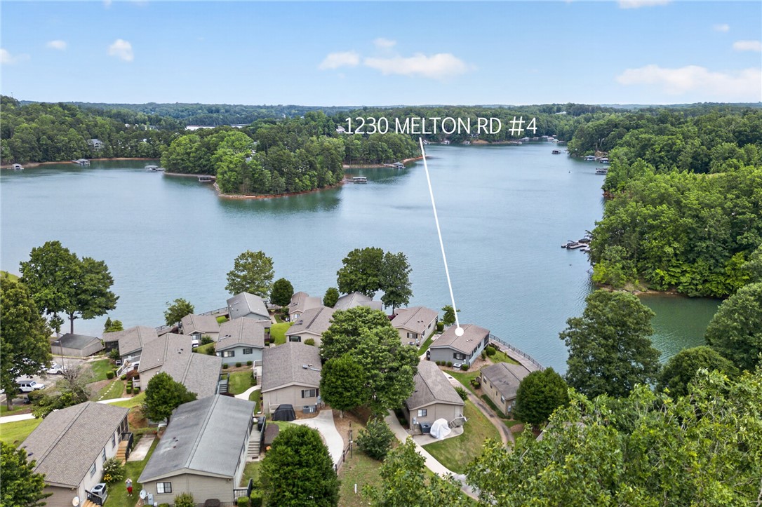 1230 Melton Road, Unit 4 West Union, SC 29696 - Photo 2 of 48 An aerial panorama showcases a serene lakeside community nestled amidst lush woodlands, offering tranquil water views.