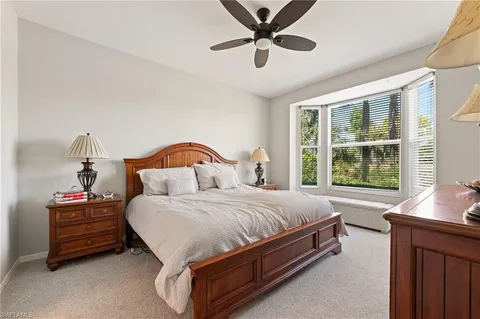 a bed sitting in a bedroom next to a window