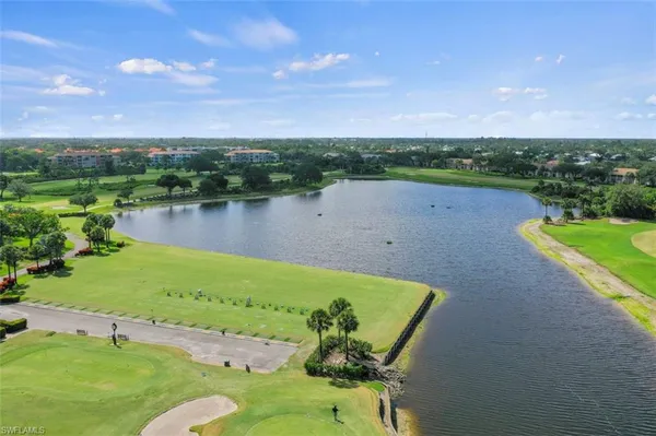 a view of a lake with houses in the back