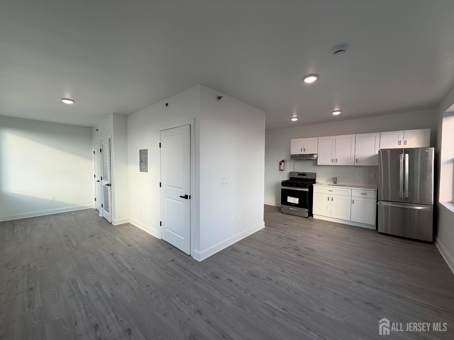 103 Bayard Street, Unit 16 New Brunswick, NJ 08901 - Photo 2 of 5 a view of kitchen with wooden floor