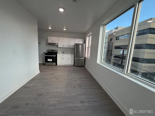 a view of a kitchen with a sink and a refrigerator