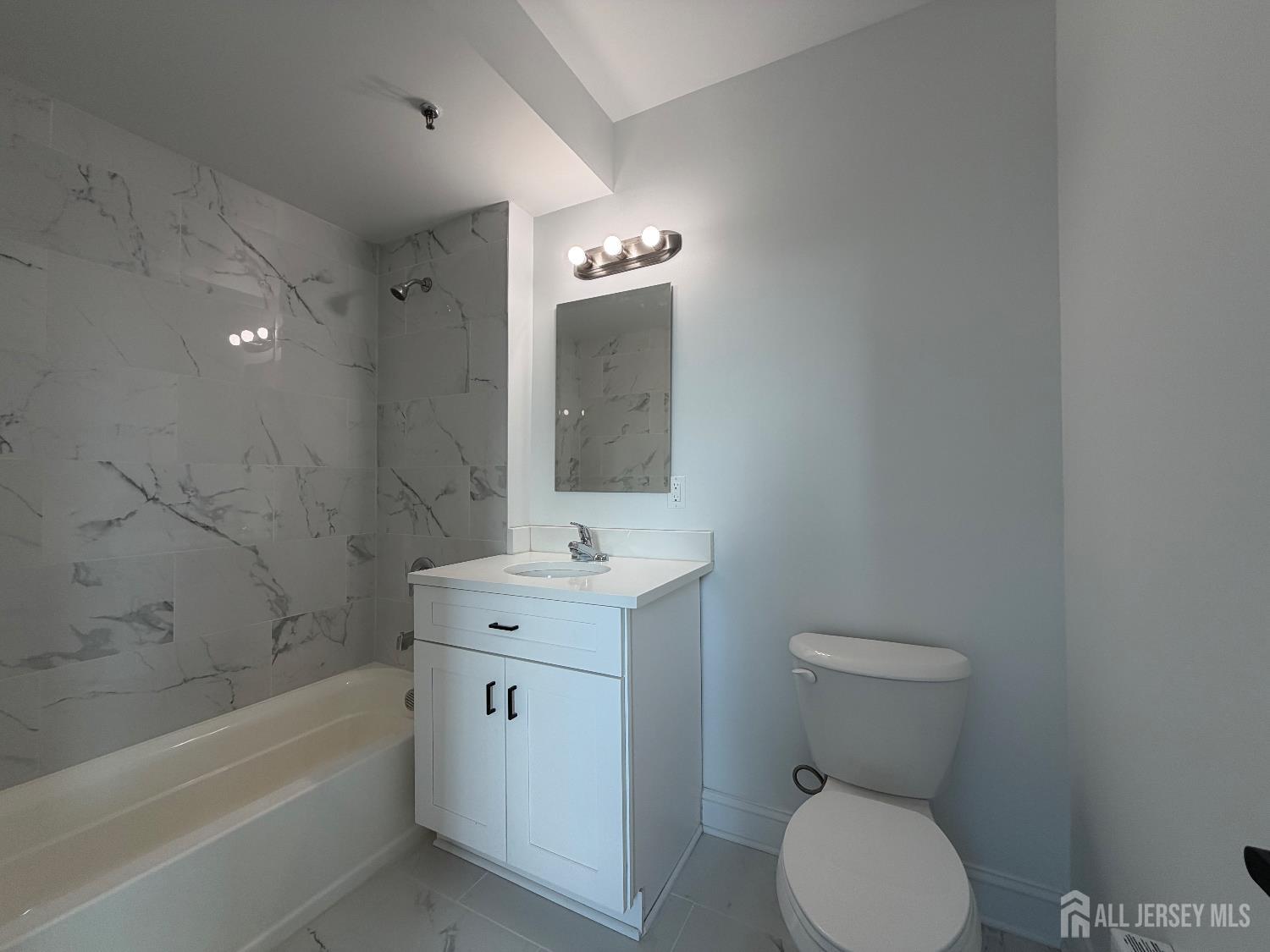 103 Bayard Street, Unit 16 New Brunswick, NJ 08901 - Photo 5 of 5 a bathroom with a toilet a sink and bathtub