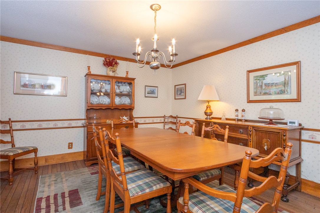 911 State Rd S-4-203 Belton, SC 29627 - Photo 14 of 49 A classic dining room features warm hardwood flooring and a charming chandelier, perfect for intimate gatherings.