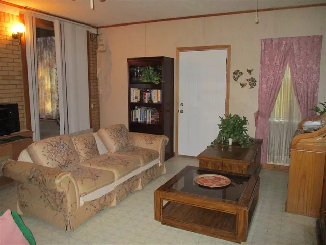 a bed sitting in a room next to a window