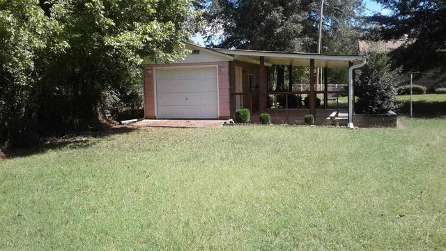 a view of a house with yard and sitting area