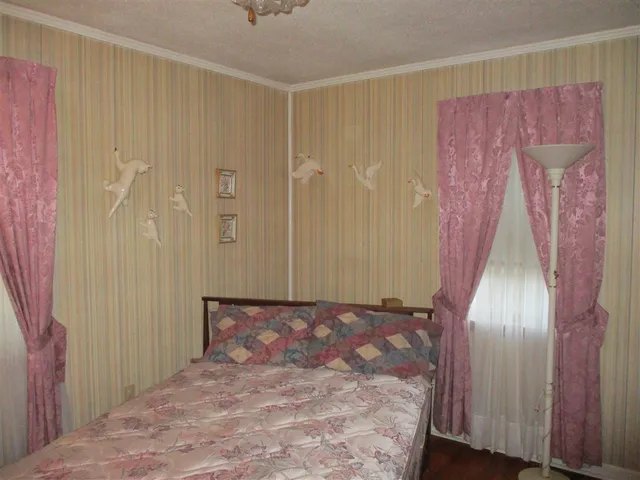 a bedroom with furniture and a chandelier