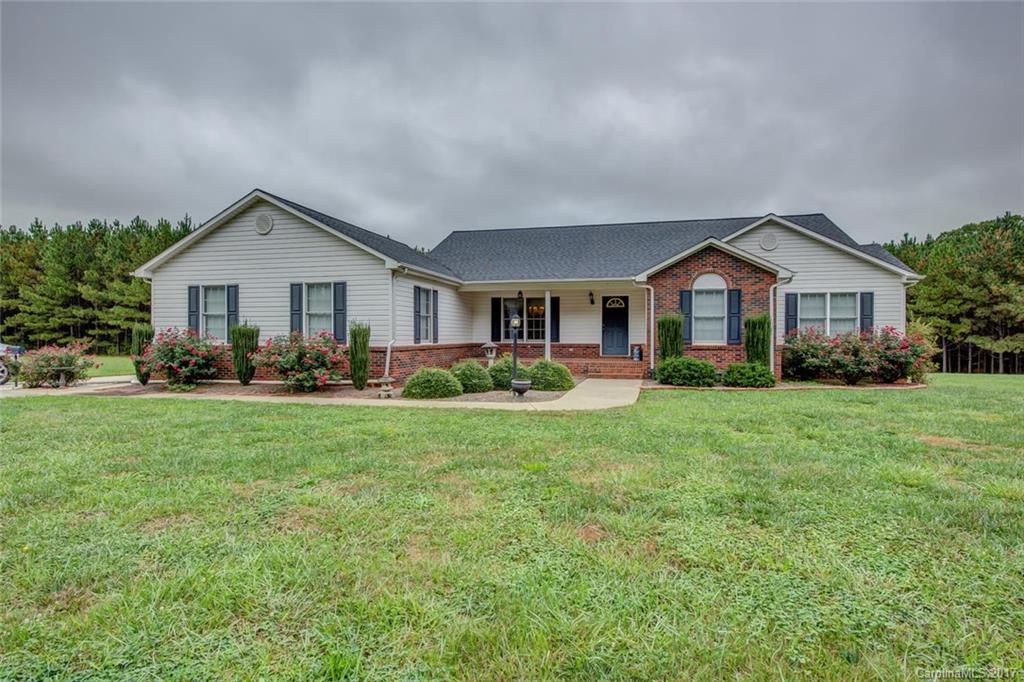 404 Loray Farm Road Dallas, NC 28034 - Photo 1 of 23 a front view of a house with a yard and green space