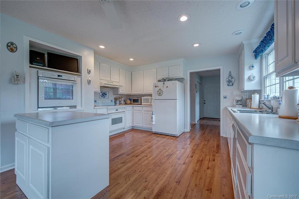 404 Loray Farm Road Dallas, NC 28034 - Photo 11 of 23 a kitchen with cabinets and wooden floor
