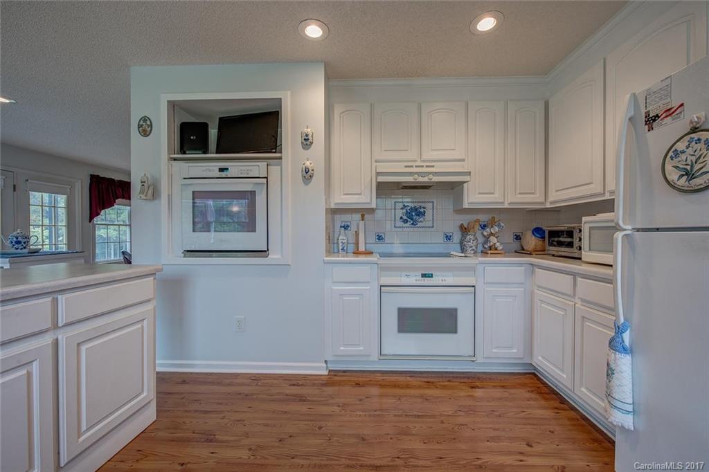 404 Loray Farm Road Dallas, NC 28034 - Photo 13 of 23 a kitchen with cabinets stainless steel appliances a sink and wooden floor
