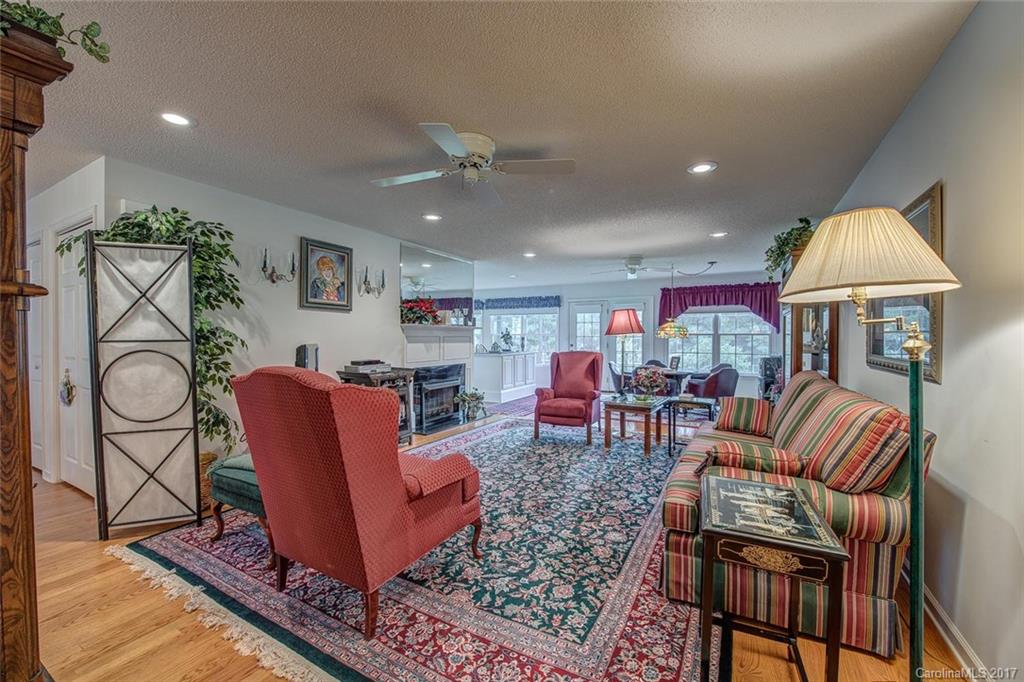 404 Loray Farm Road Dallas, NC 28034 - Photo 5 of 23 a living room with furniture a dining table and a fireplace