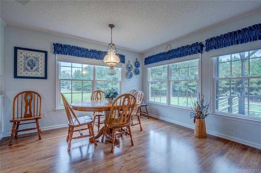 404 Loray Farm Road Dallas, NC 28034 - Photo 10 of 23 a view of a dining room with furniture window and wooden floor