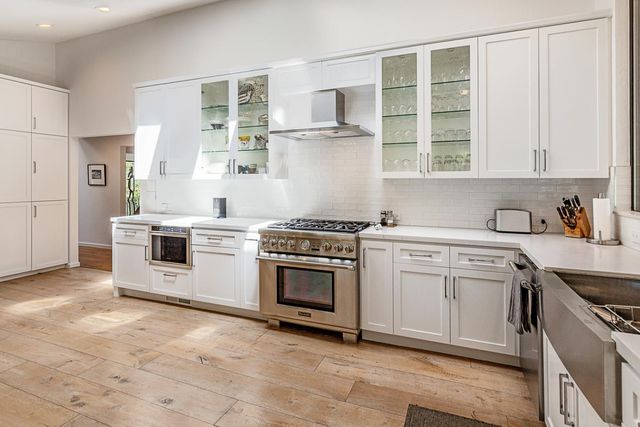 a kitchen with stainless steel appliances granite countertop a stove and a sink