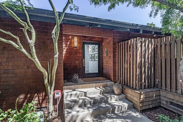 a view of a wooden door with a bench