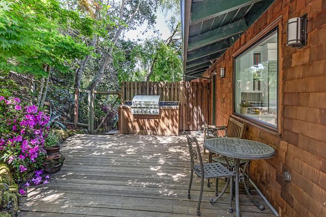 a view of backyard with table and chairs and potted plants