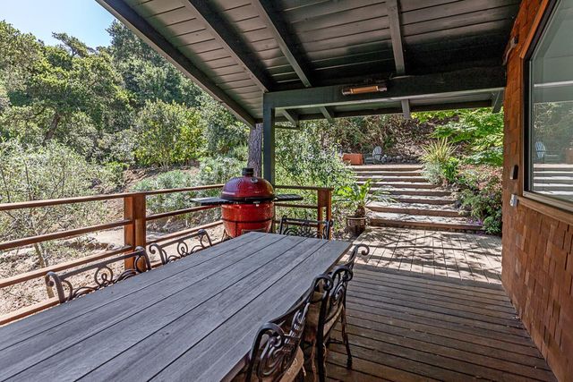 a view of a deck with wooden floor and outdoor seating