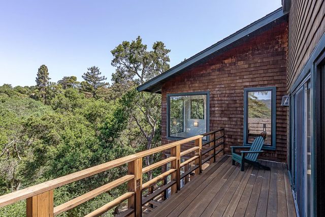 a balcony with wooden floor and furniture