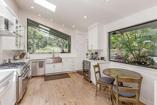 a kitchen with a table chairs stove and cabinets