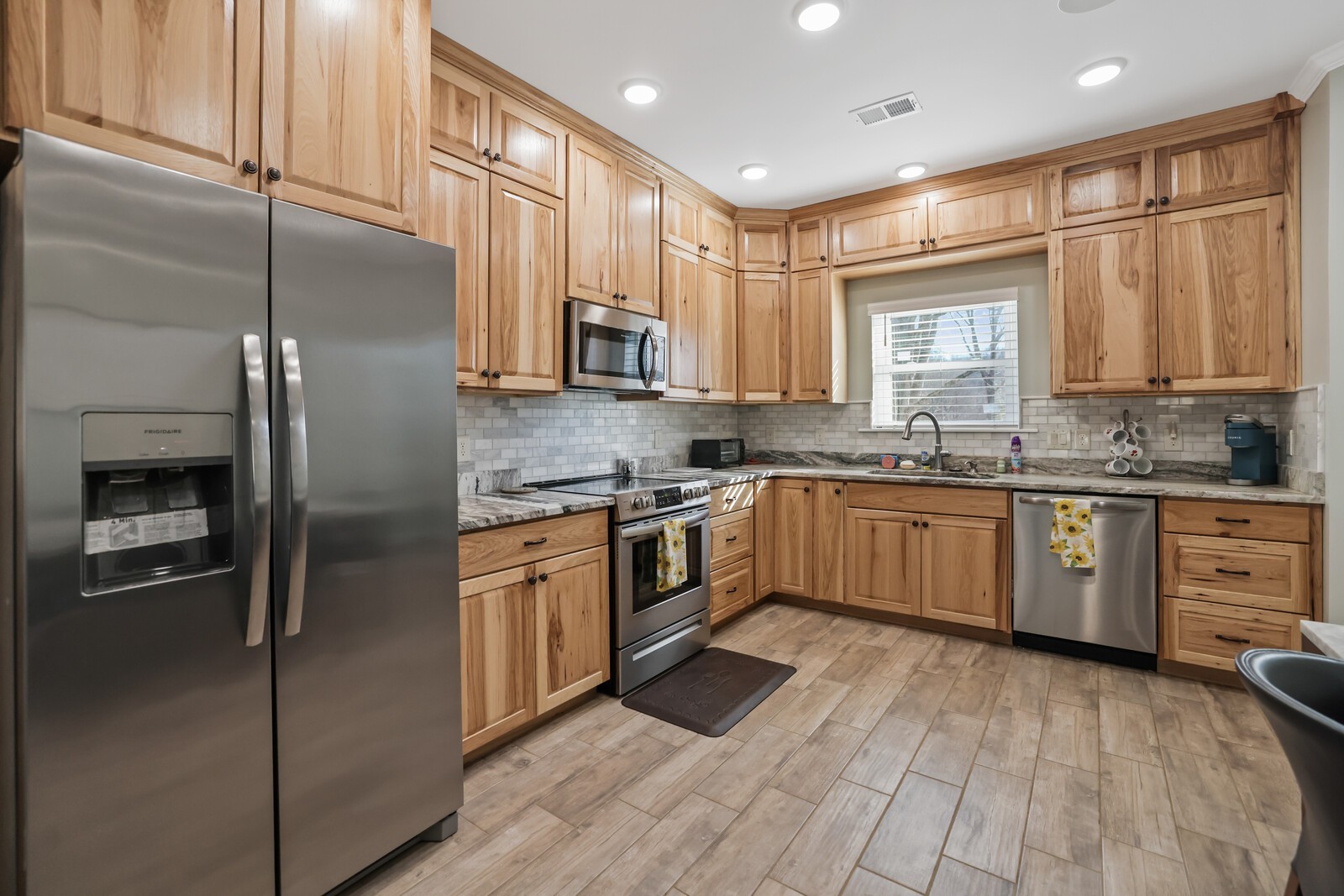 3755 Holmes Gap Road Watertown, TN 37184 - Photo 49 of 71 a kitchen with stainless steel appliances a sink cabinets and a window