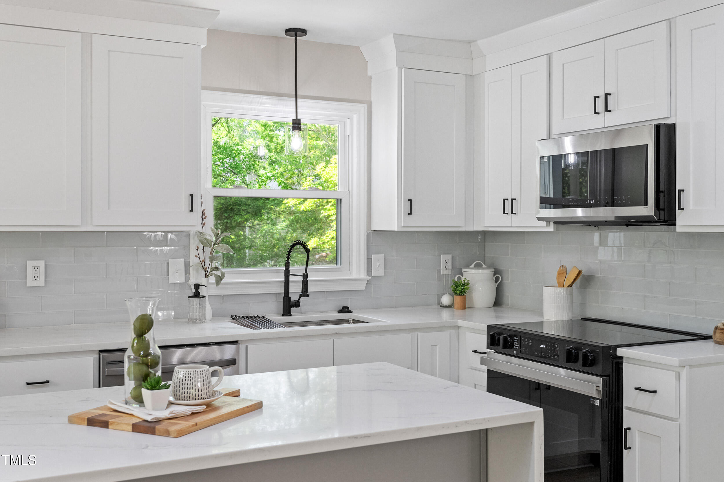1514 Goodwin Road Durham, NC 27712 - Photo 10 of 33 a kitchen with a stove a sink and a white cabinets