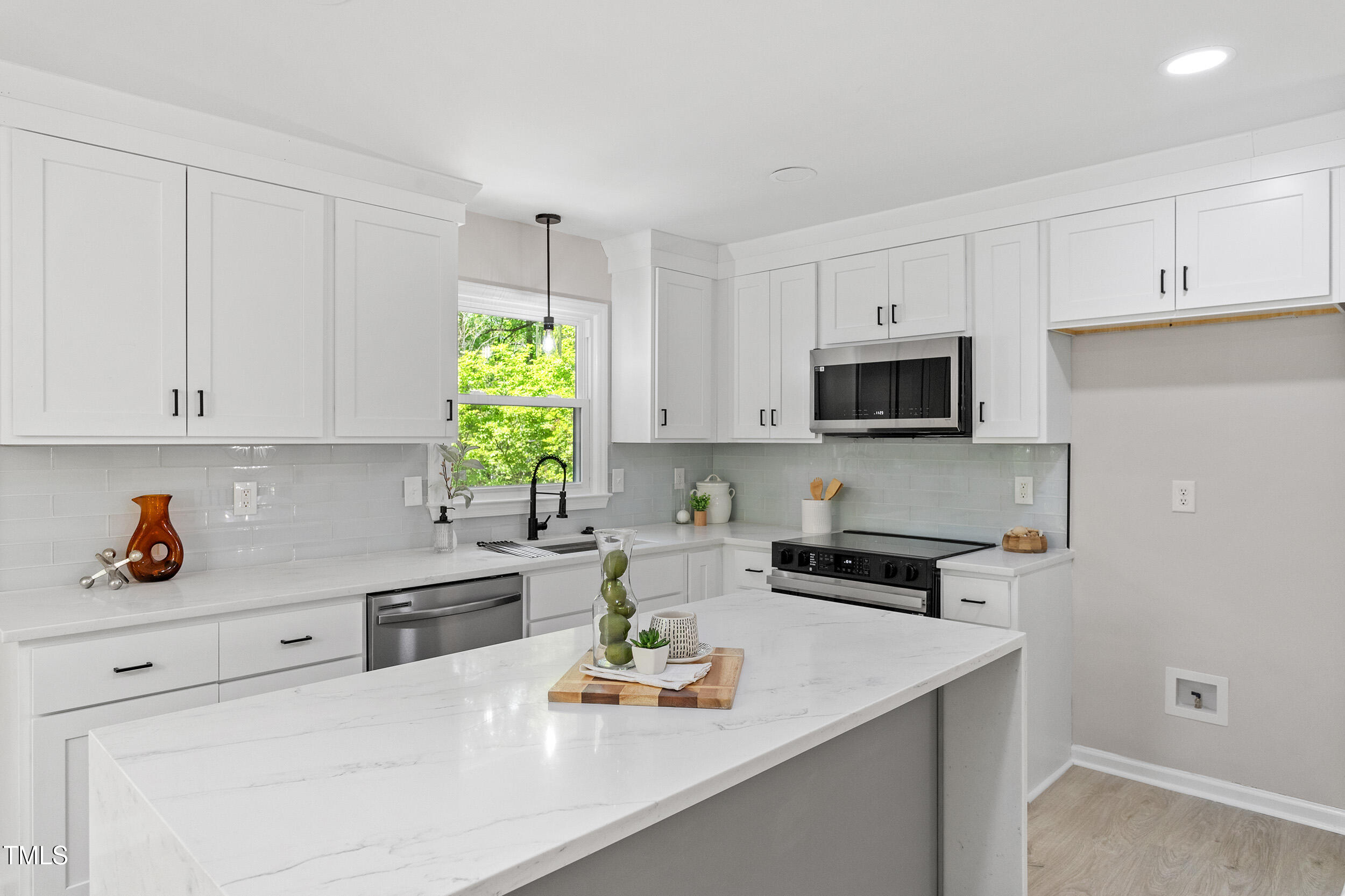 1514 Goodwin Road Durham, NC 27712 - Photo 3 of 33 a kitchen with white cabinets and appliances