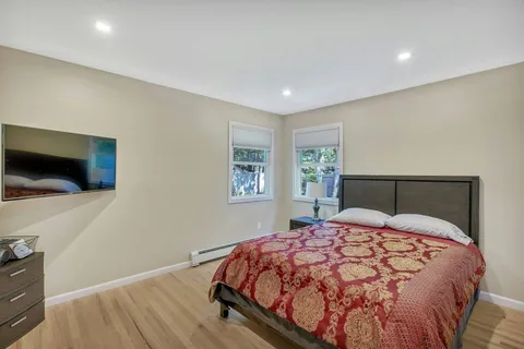 a bedroom with a large bed and a flat screen tv