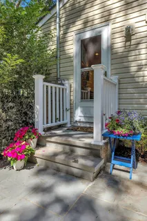 a view of backyard with seating space and potted plants