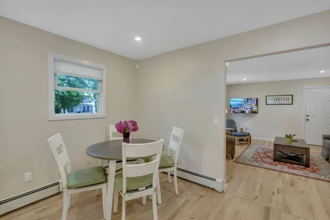a dining room with furniture and wooden floor