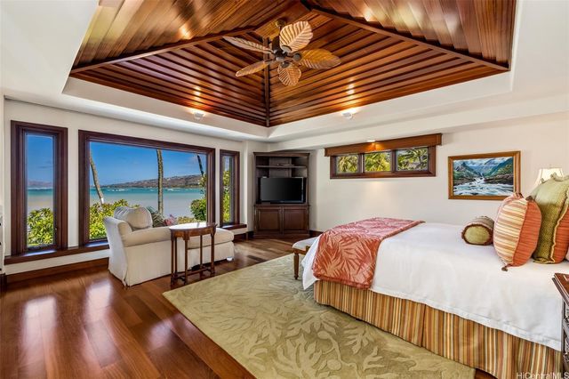 a bedroom with furniture and a large window