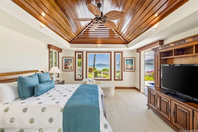 a bedroom with a large bed and a flat screen tv