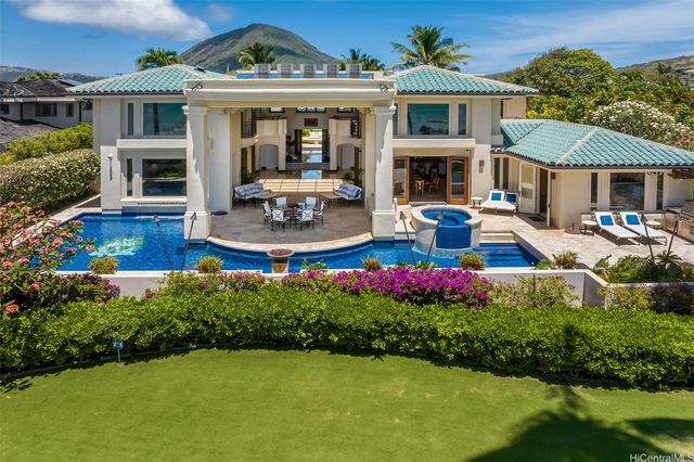 a front view of house with yard and outdoor seating