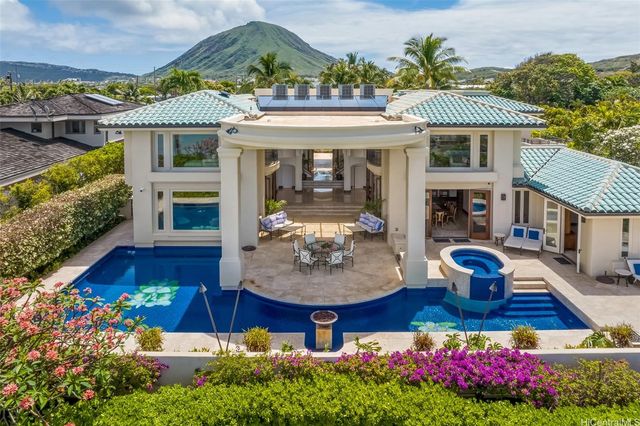 a front view of a house with yard swimming pool and outdoor seating