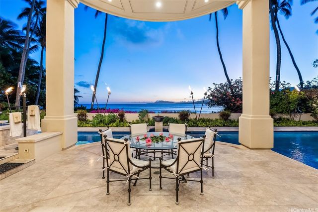 a view of an outdoor sitting area with furniture and umbrella