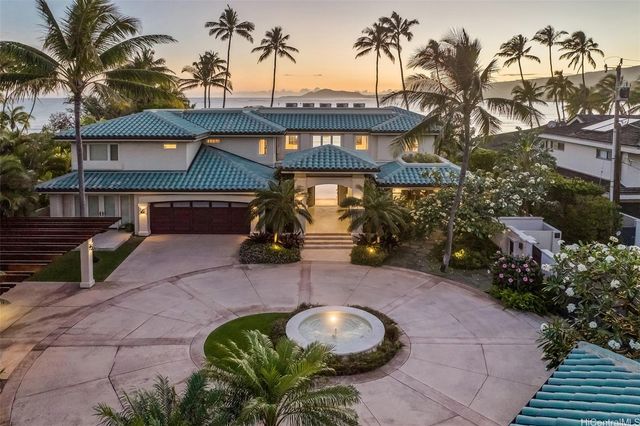 a backyard of a house with table and chairs potted plants