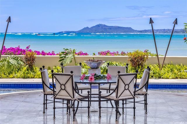 a dining area with furniture and a garden