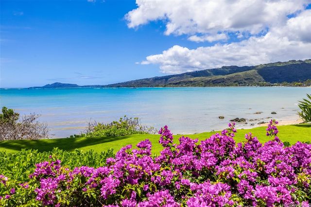 a view of a lake with a house in the background