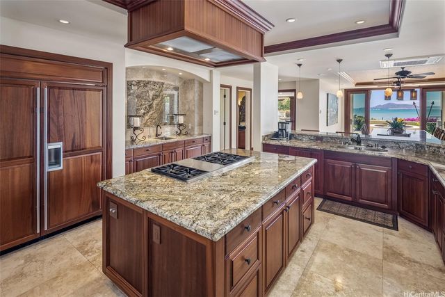 a kitchen with center island and stainless steel appliances