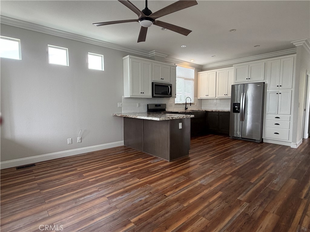 31130 South General Kearny Road Temecula, CA 92591 - Photo 4 of 18 a kitchen with stainless steel appliances granite countertop a refrigerator a stove top oven a sink and dishwasher