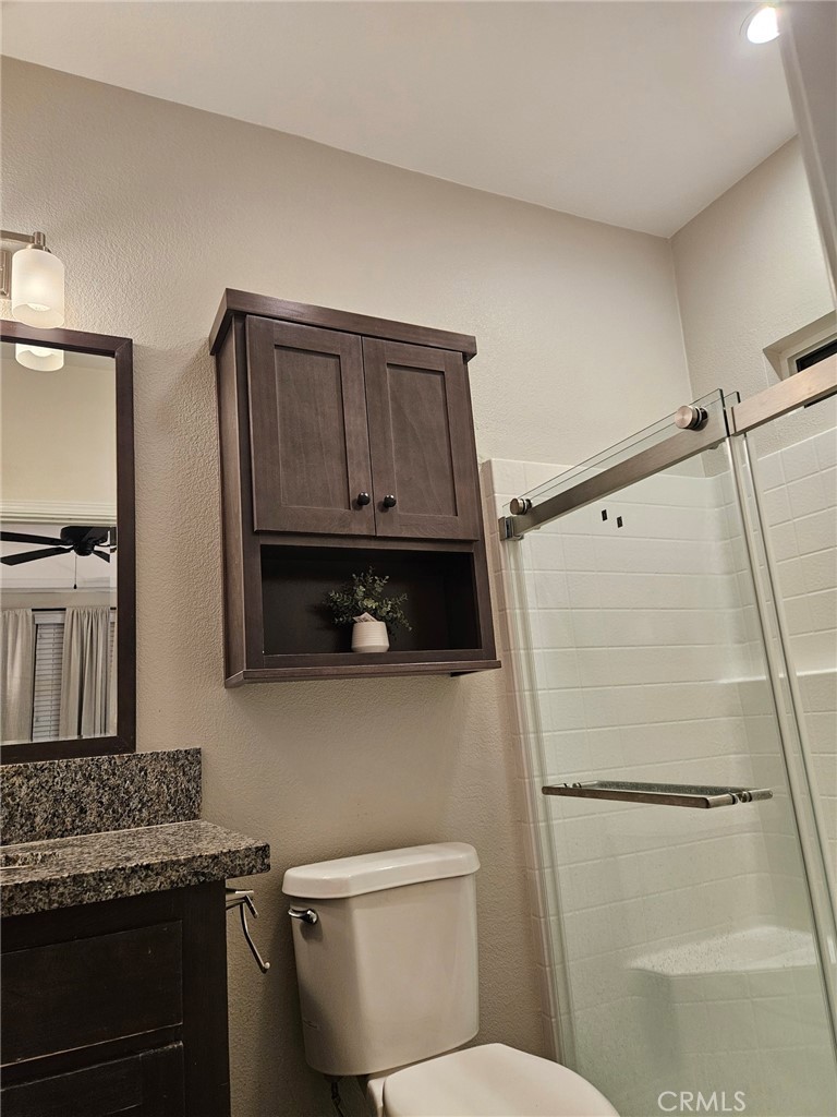 31130 South General Kearny Road Temecula, CA 92591 - Photo 8 of 18 a bathroom with a granite countertop sink toilet and shower