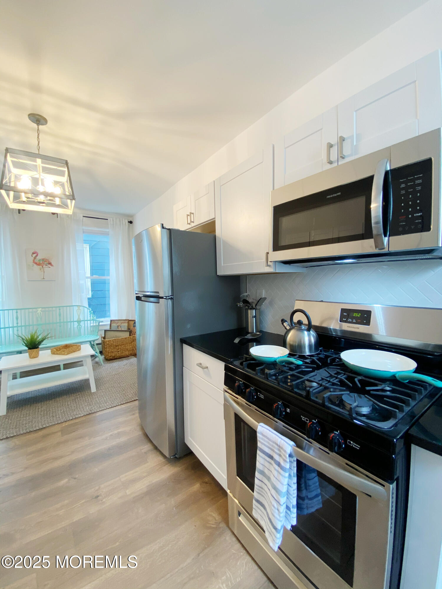 22 Embury Avenue, Unit 1 Ocean Grove, NJ 07756 - Photo 11 of 14 a kitchen with stainless steel appliances granite countertop a stove a refrigerator and a stove