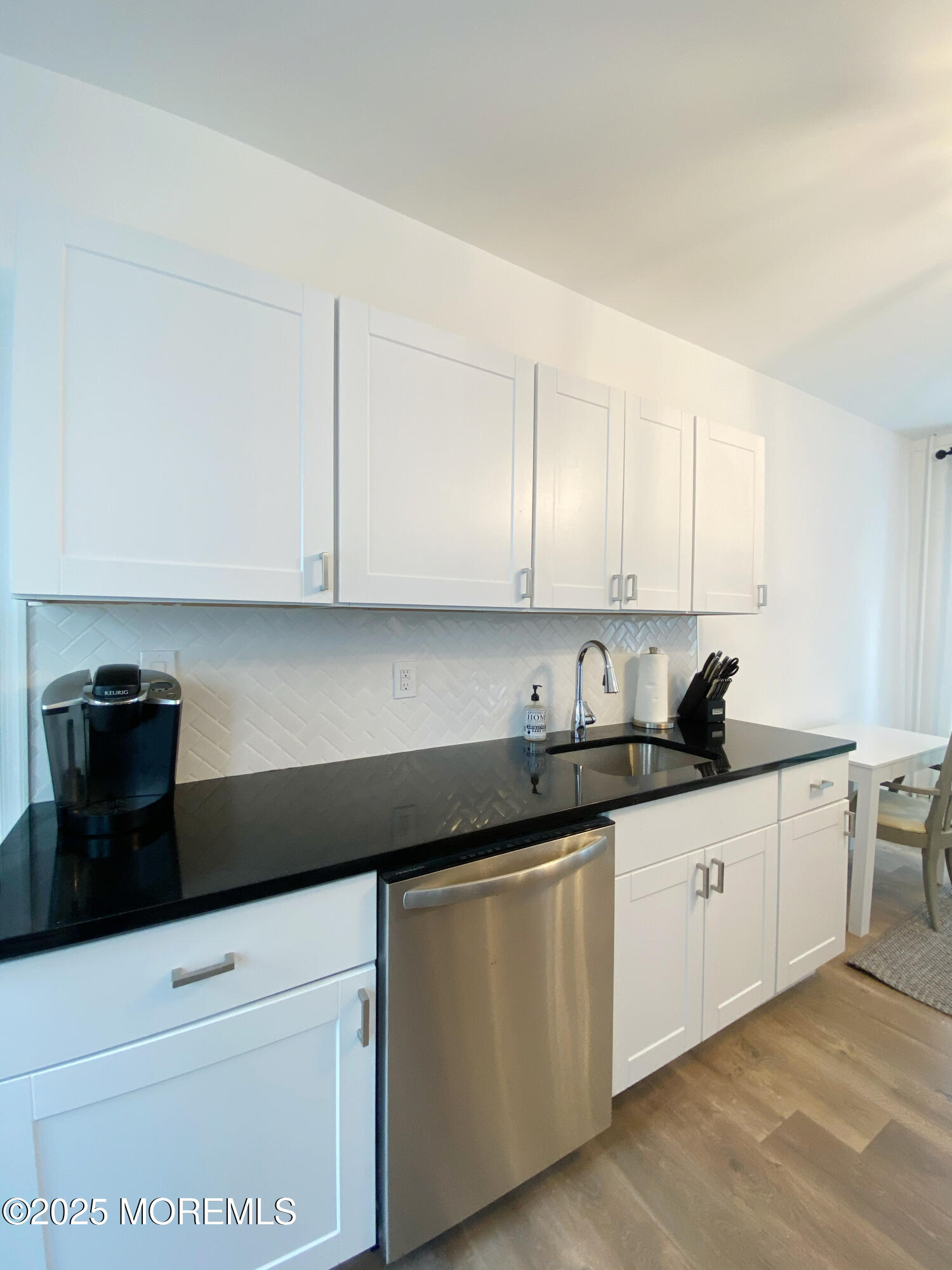 22 Embury Avenue, Unit 1 Ocean Grove, NJ 07756 - Photo 13 of 14 a kitchen with granite countertop white cabinets and sink