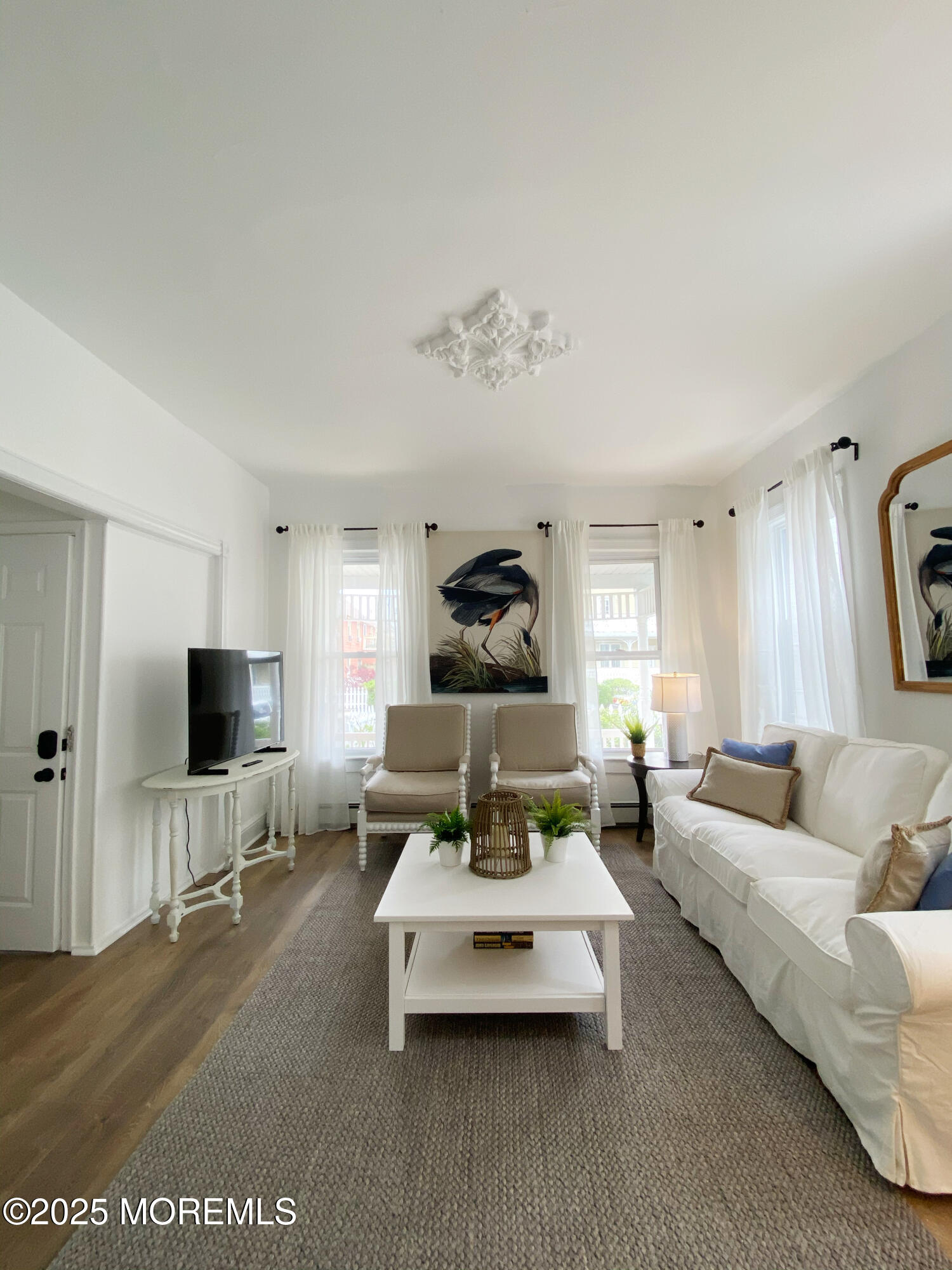 22 Embury Avenue, Unit 1 Ocean Grove, NJ 07756 - Photo 4 of 14 a living room with furniture and a flat screen tv