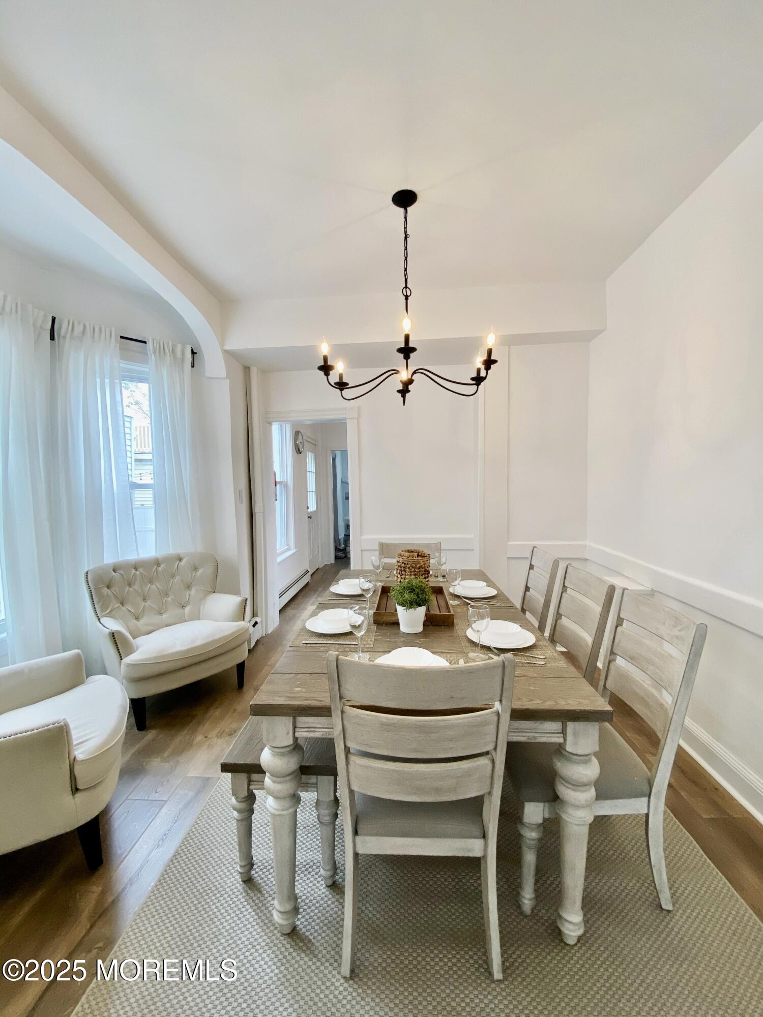 22 Embury Avenue, Unit 1 Ocean Grove, NJ 07756 - Photo 8 of 14 a dining room with furniture and wooden floor