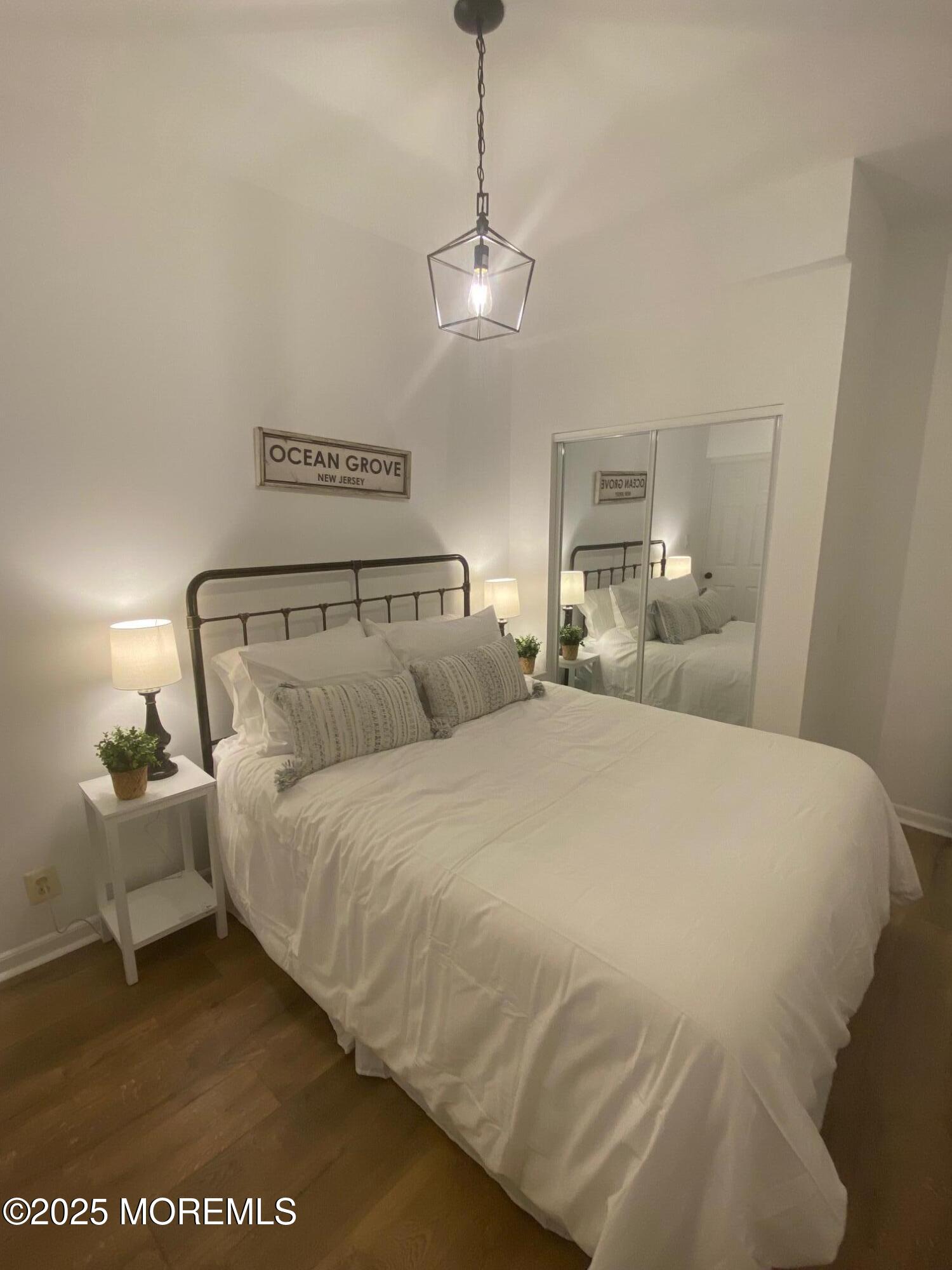 22 Embury Avenue, Unit 1 Ocean Grove, NJ 07756 - Photo 10 of 14 a bedroom with a bed and window