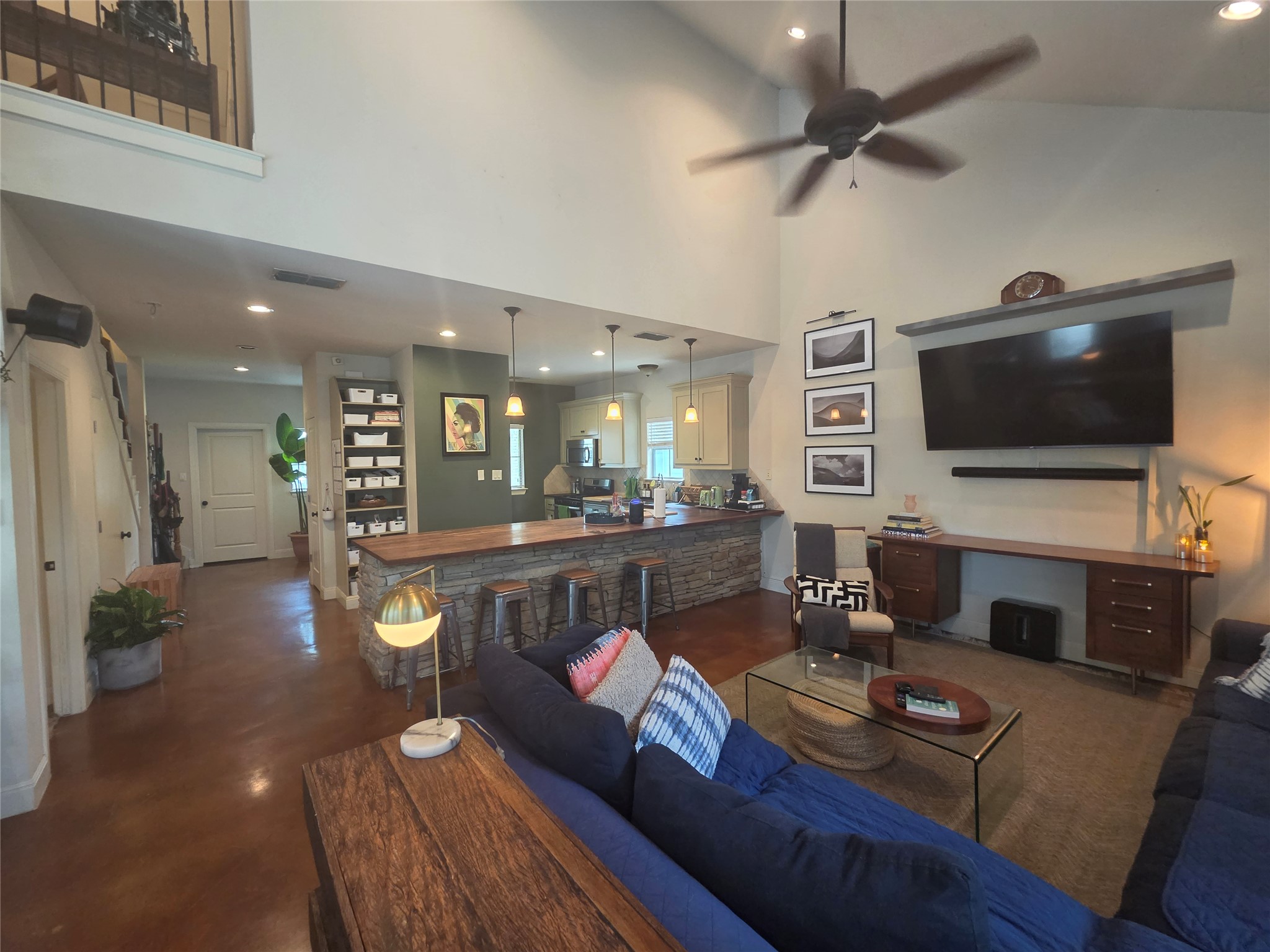 408 West Croslin Street Austin, TX 78752 - Photo 5 of 29 Natural light illuminates this spacious living area with soaring ceilings and an open-concept kitchen.