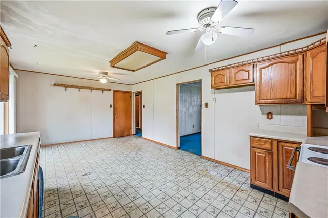 a view of a kitchen with a sink and cabinet with wooden floor