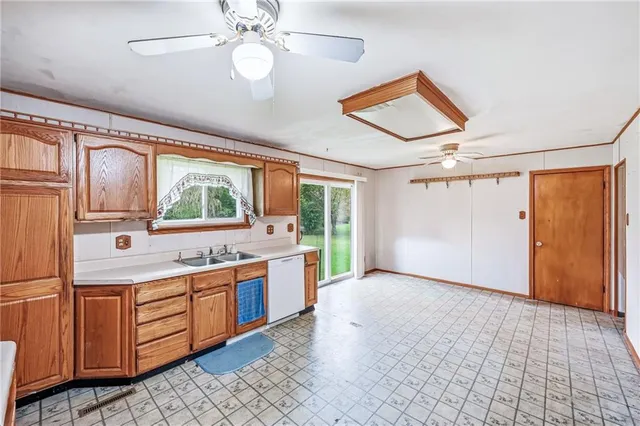 a kitchen with stainless steel appliances kitchen island granite countertop a stove a sink and a refrigerator
